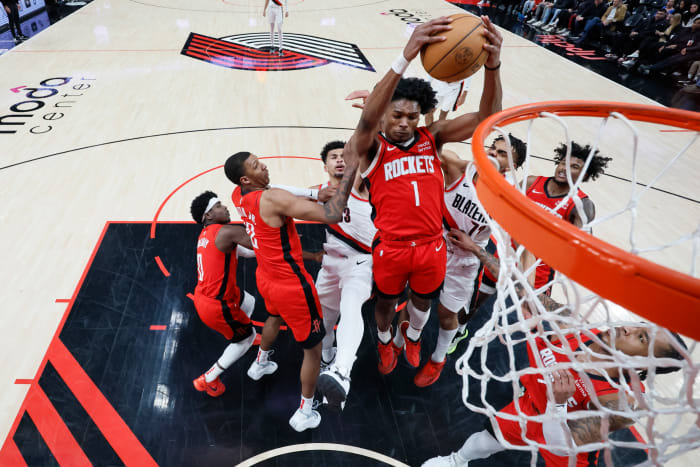 Rockets' Amen Thompson (1) comes down with a rebound next to Portland Trail Blazers forward Rayan Rupert (72) during the second half at Moda Center.